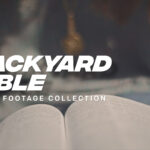 Young girl reading the Bible in her backyard on a sunny day