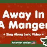 "Away In A Manger Sing Along Lyric Video" text in white on red background with snowflakes and illustrated Christmas trees with ornaments for children's worship