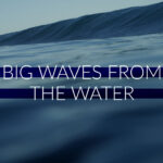 Cinematic slow-motion footage of large ocean waves crashing and rolling with deep blue water and white sea foam.