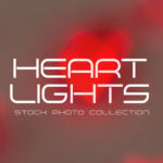 Glowing red heart-shaped string light hanging against a light wooden background, symbolizing love and warmth.