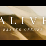"Alive Easter Opener" text in elegant white serif font over soft blurred golden fabric with flowing movement for church Easter video