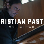 A cinematic shot of a pastor studying the Bible and reflecting in a quiet church environment.