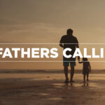 A heartwarming, cinematic Father's Day church visual from the A Fathers Callingmini-movie, showing the rear silhouette of a father holding his young child's hand as they walk along a sandy beach at sunset, with bold white typography reading "A FATHERS CALLING."